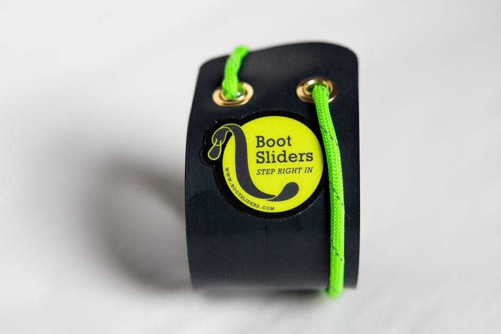 Frontal and centered view of Boot Slider product, rolled up, with "Electric Green" colored logo and paracord.